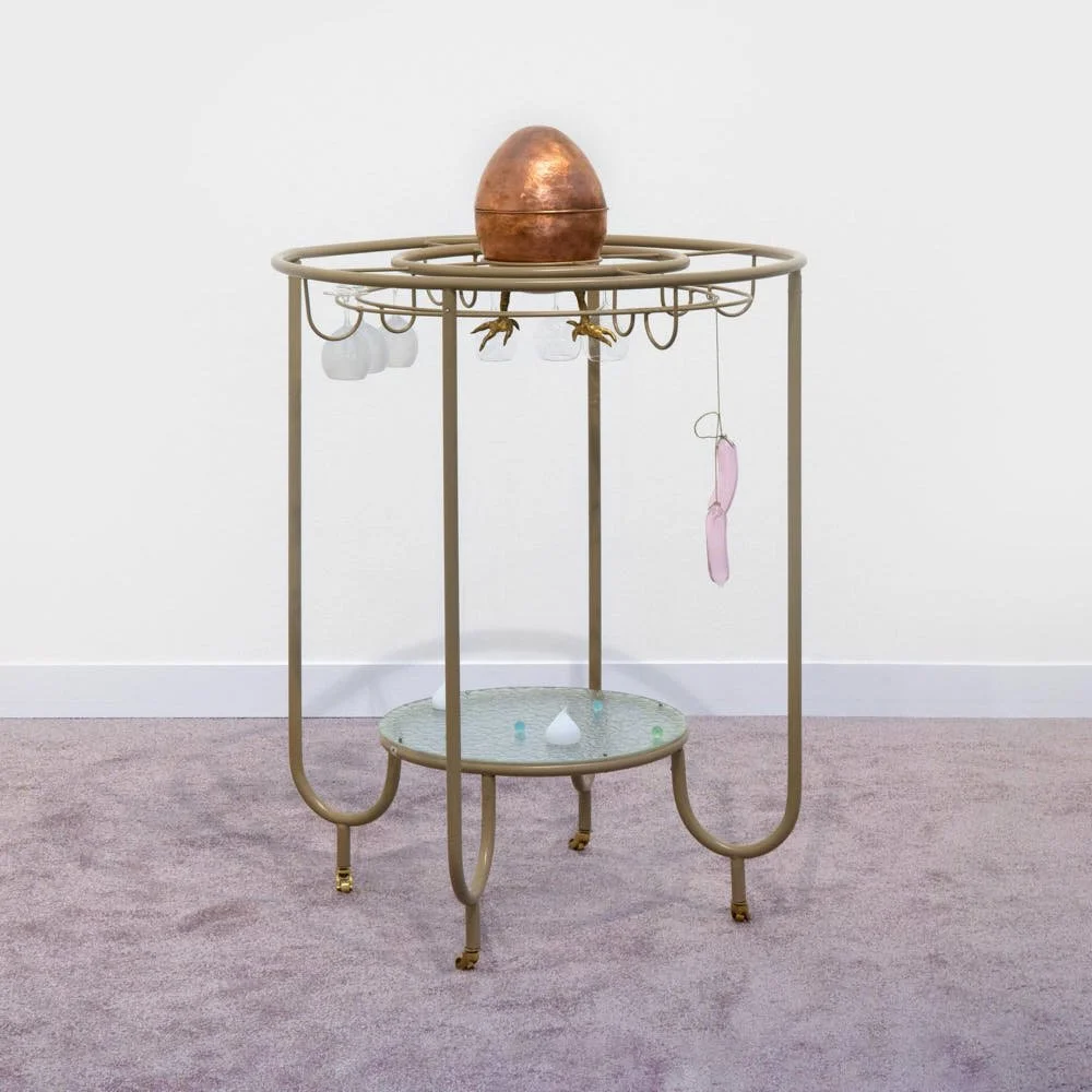 Golden Egg's Matinee, 2026, Hand-blown glass, powder-coated mild steel, copper, bronze, brass, string, 126 x 82 x 82 cm. Frieze London. Public, London, 2026 LE MILE Magazine reviewed by editor Tagen Donovan