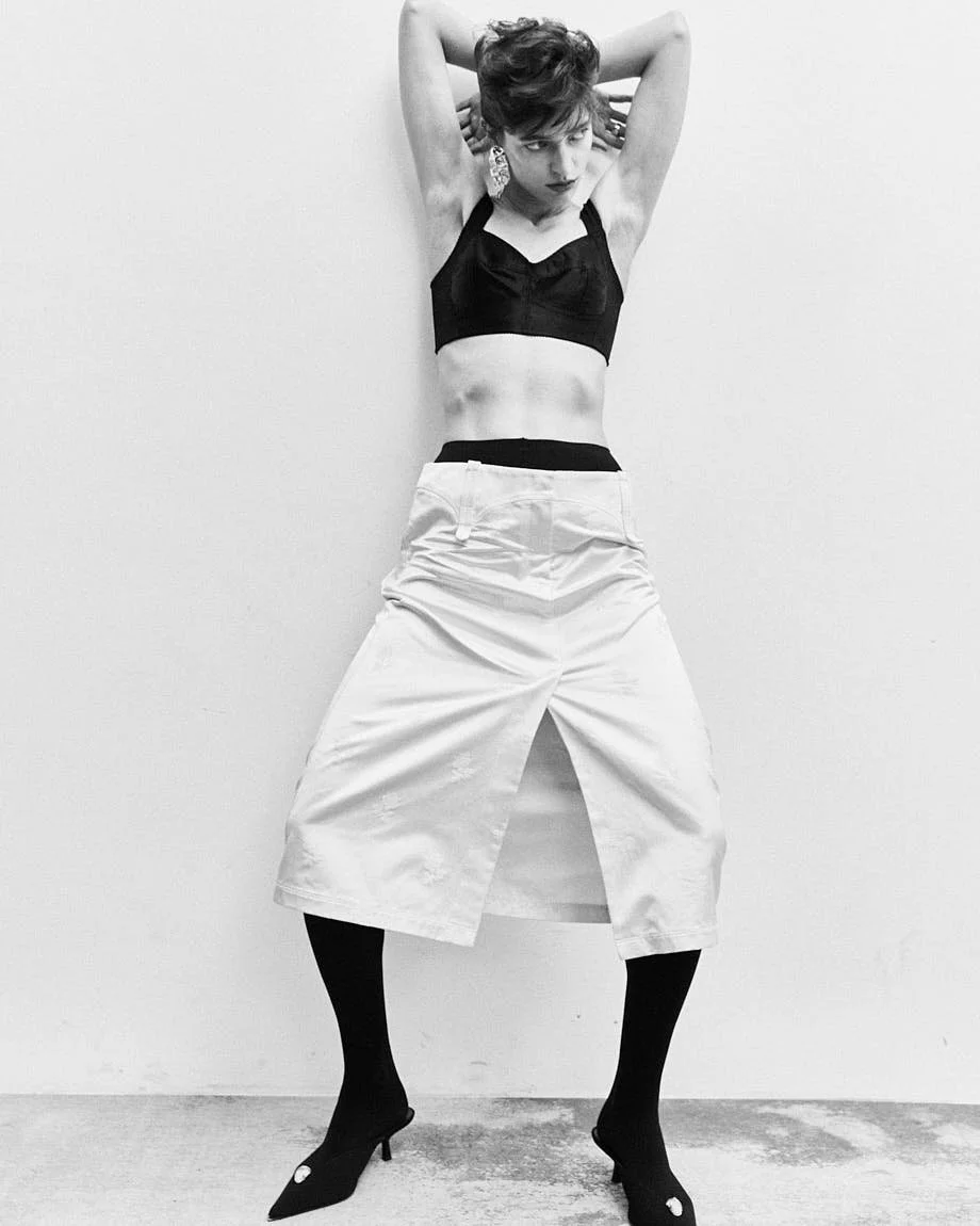 CATERINA DEORDIEVA LE MILE Magazine Antonio Grotti editorial SS26 womenswear Caterina wears top by DOLCE&GABBANA, skirt by TORY BURCH, shoes by GIUSEPPE ZANOTTI, jewellery by VOODOO JEWELS and tights by CALZEDONIA