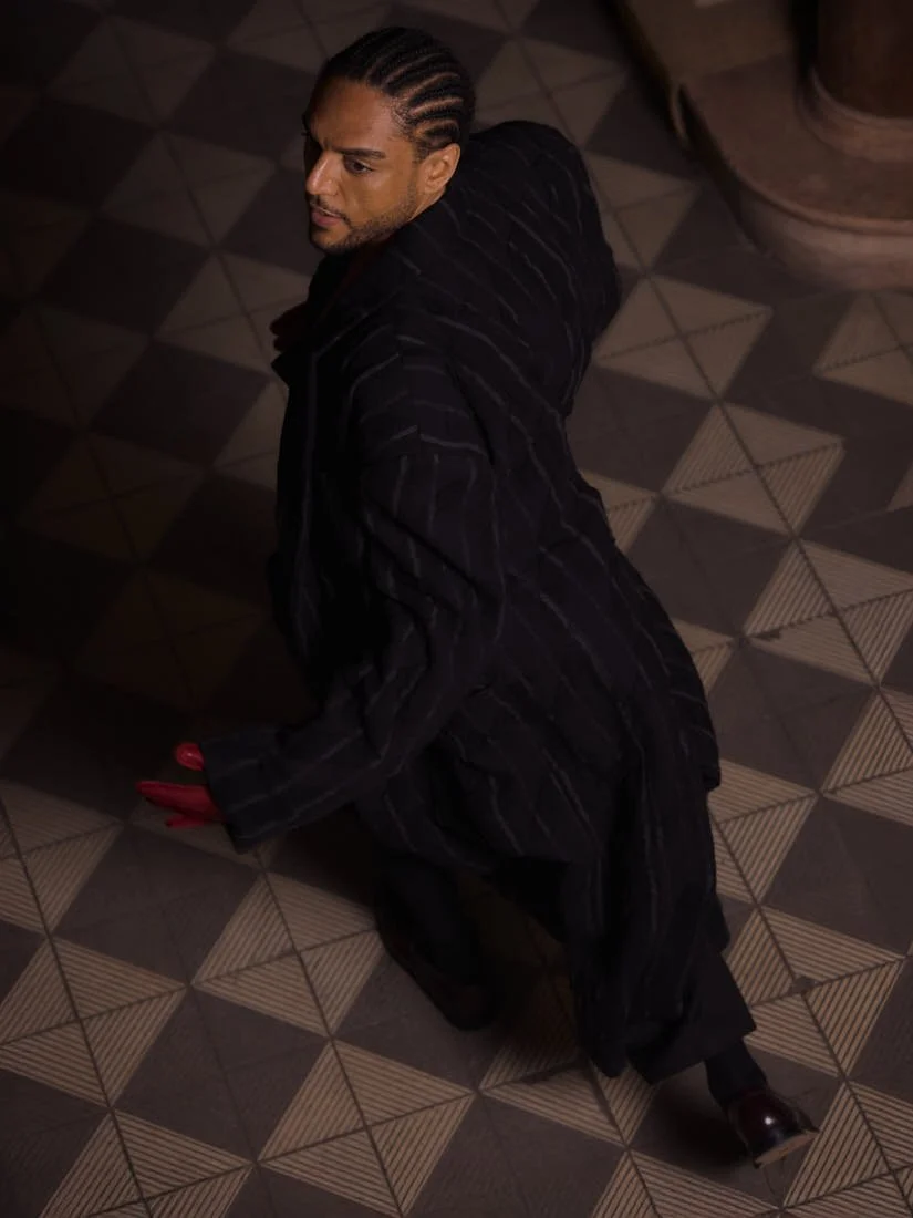 Lamin Leroy Gibba stylist Klass Hammer photo Leon Nevill Gallagher LE MILE Magazine Lamin wears a coat by Juun.J, a blazer and pants by Karl Lagerfeld, and gloves by H&M Studio