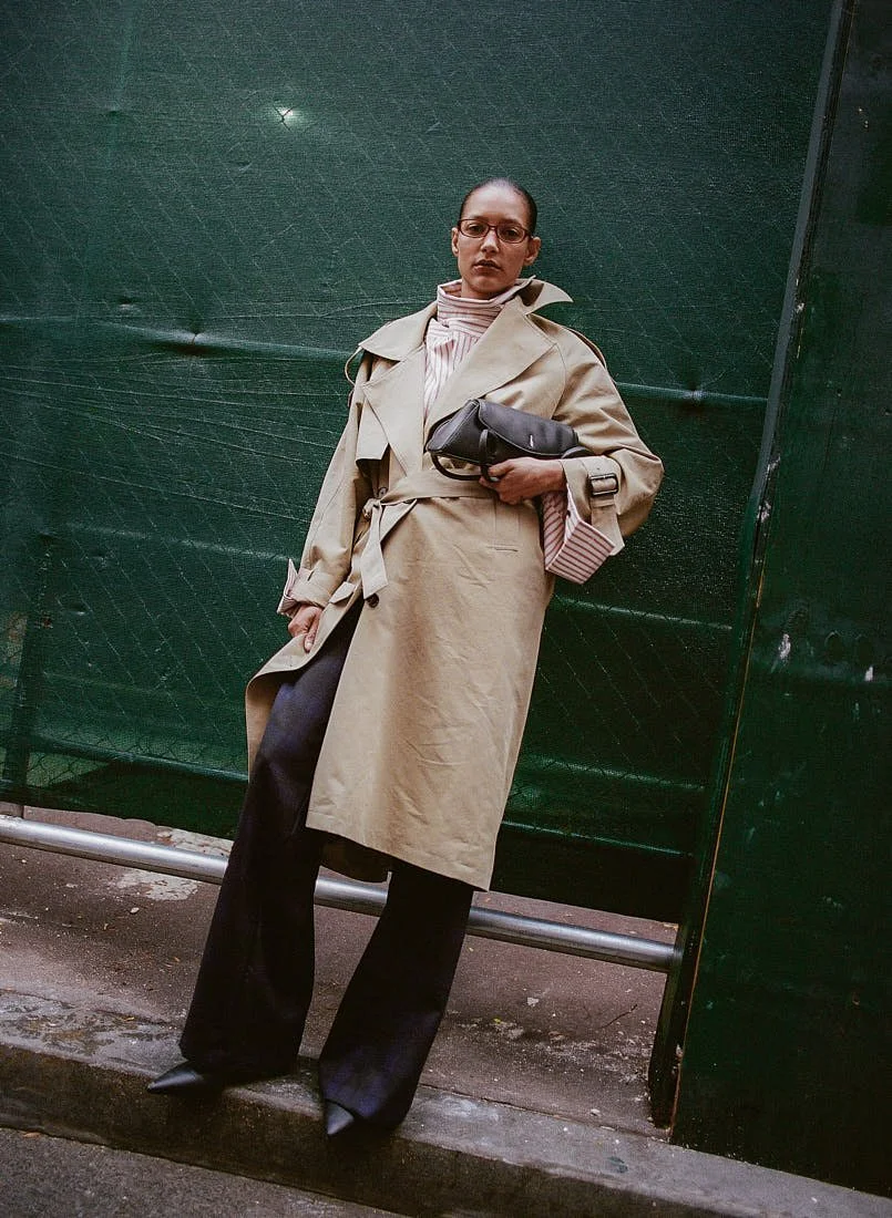CHRIS SAULNIER LE MILE Magazine NYC WINTER BREATH FW25 Story Maria wears a trench coat and striped shirt by Wàngda, a bag by Behno, pants by Pence, and shoes by Femme Liberee