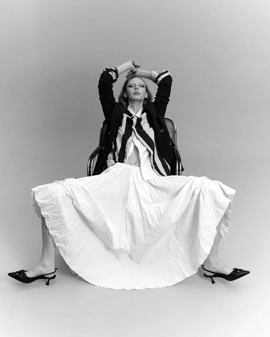 BRYDIE CLEVERINGA LE MILE Magazine SS26 Womenswear Editorial look Brydie wears blazer and white shirt by MICHAEL KORS, striped shirt by ARTHUR ARBESSER, skirt by MEIMEIJ, shoes by APEPAZZA