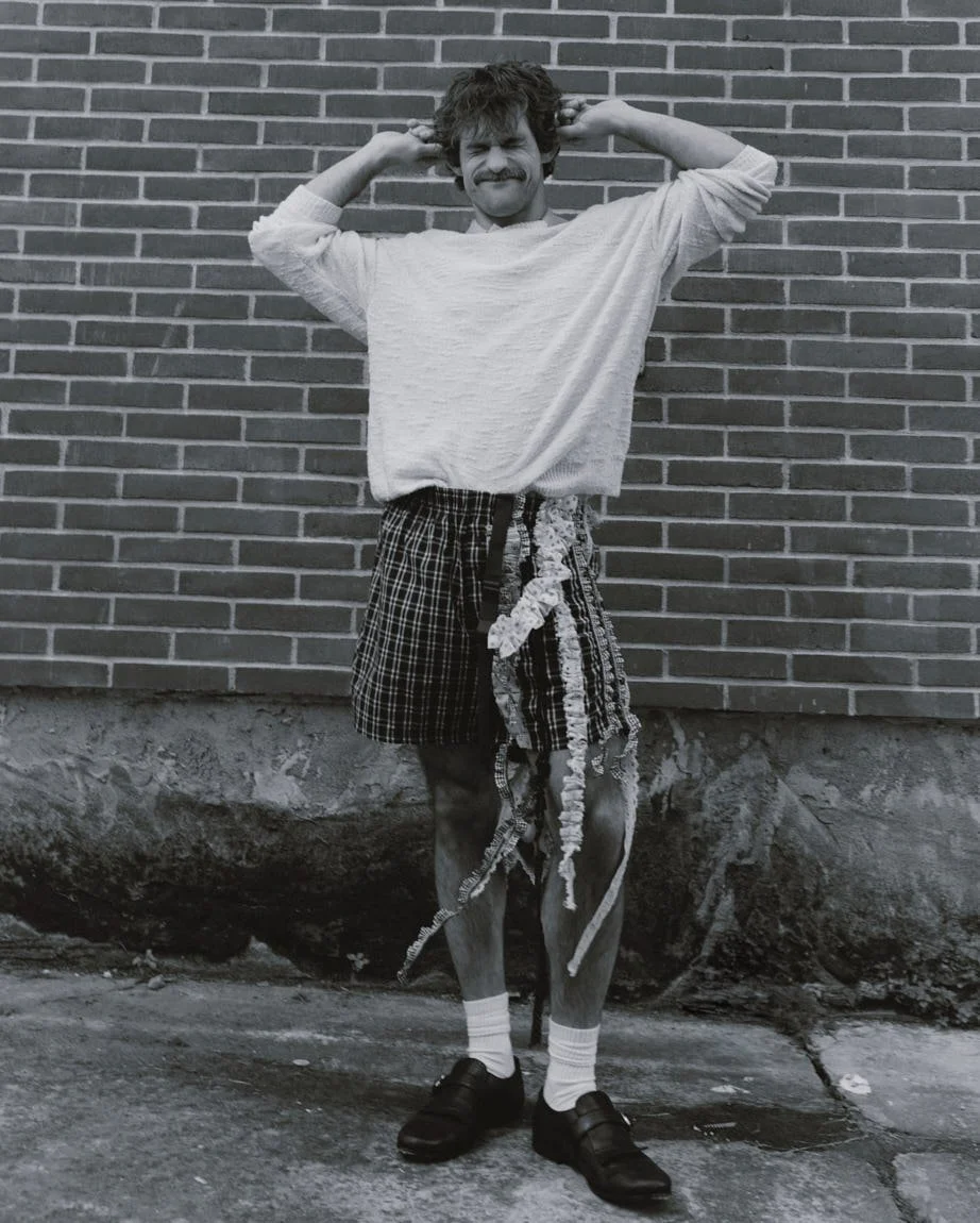 IVAN UGRIN for LE MILE Magazine photo by Andrea Cenetiempo SS26 Ivan wears a sweater by ISABEL MARANT, shirt by LOUIS VUITTON, shorts by LESSICO FAMILIARE and shoes by CHURCH’S