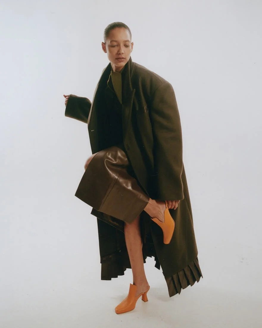 CHRIS SAULNIER LE MILE Magazine NYC WINTER BREATH FW25 Story Maria wears a coat by Wàngda, a top with tie by Mola Walker, a skirt by Pier Antonio Gaspari, and shoes by Femme Liberee