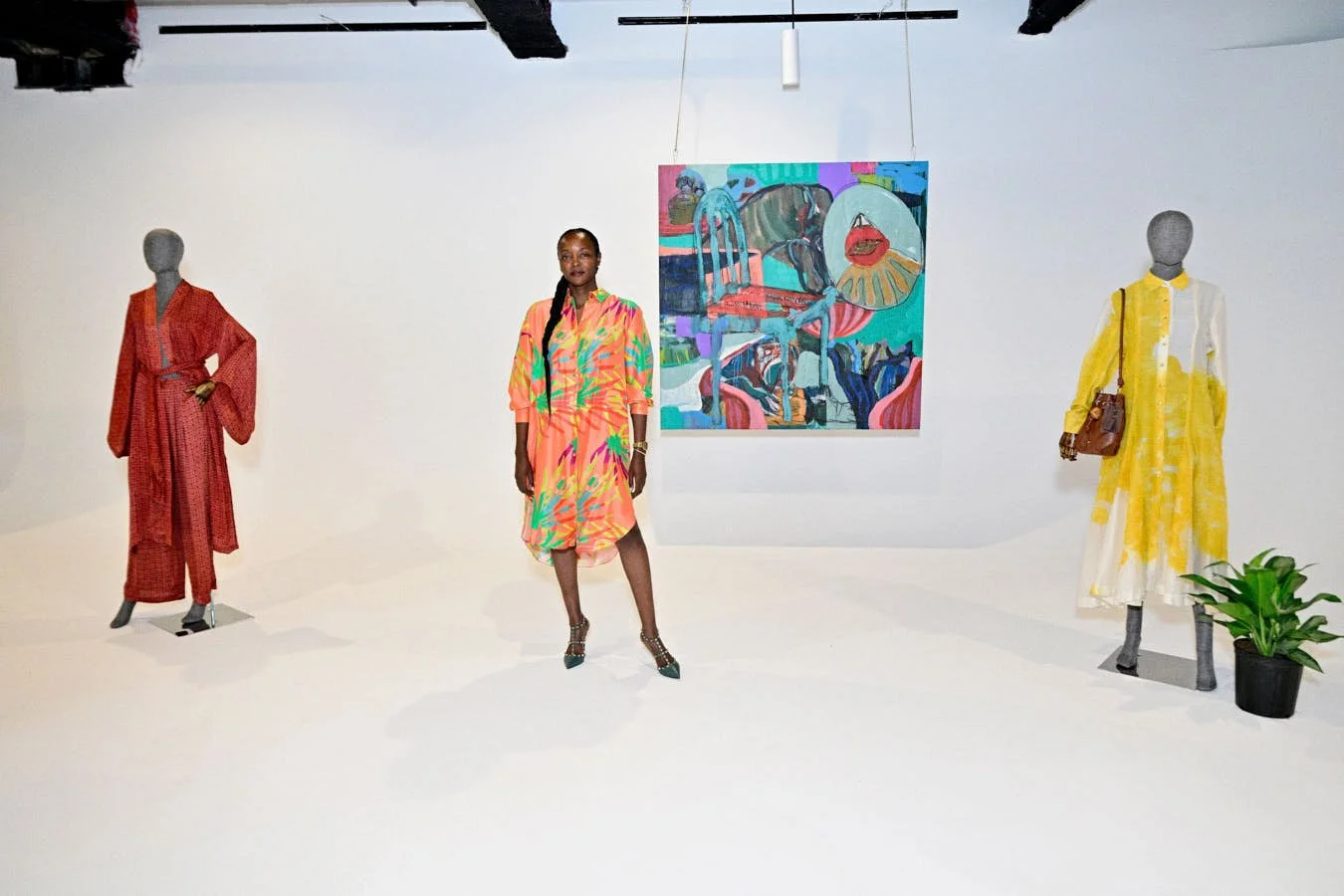nterior of Priscilla Chigariro’s retail concept The Sp_ce, featuring mannequins displaying contemporary fashion alongside colorful artwork.
