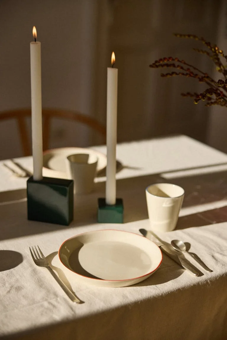 onomao Aberta collection with orange-rimmed stoneware tableware and green candle holders from GMK x onomao, LE MILE Magazine.