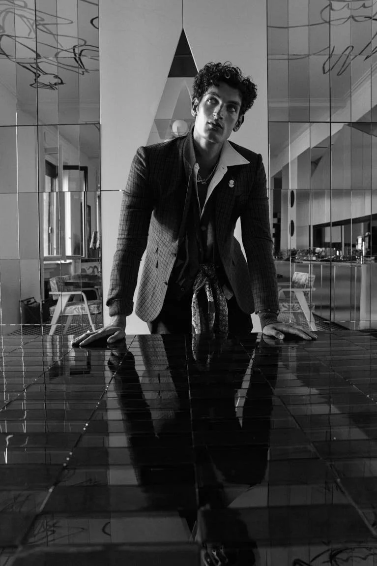 Aaron Shandel for LE MILE Magazine photographer Cosimo Buccolieri Issue 41 FW26 Deja Vu Cover Aaron wears a blazer by EMPORIO ARMANI, cardigans by VERSACE and ACNE STUDIOS, a shirt by DSQUARED2, pants by MOSCHINO and jewellery by LAG WORLD
