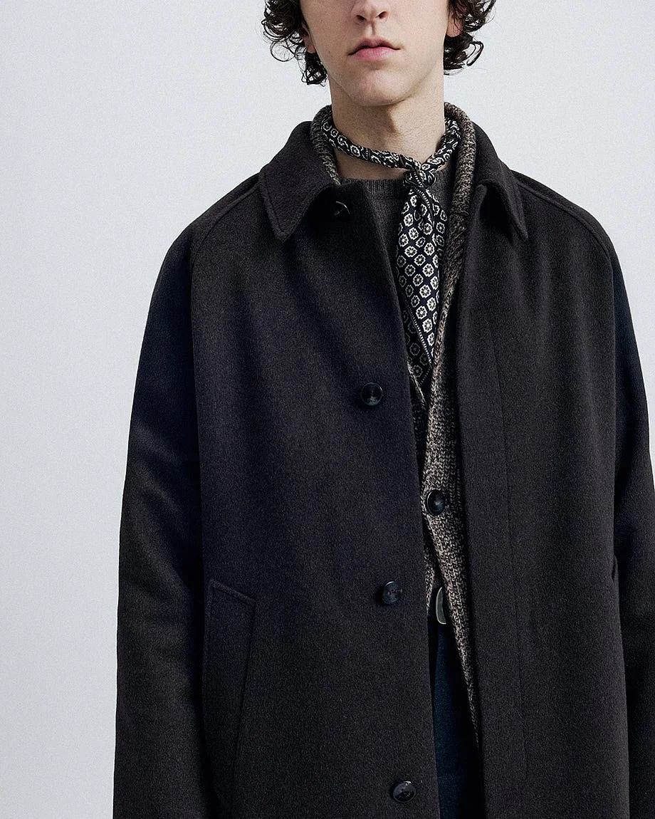 AGNONA Autumn/Winter 2026 menswear detail with dark wool coat, textured knitwear and patterned silk neck scarf, LE MILE Magazine.