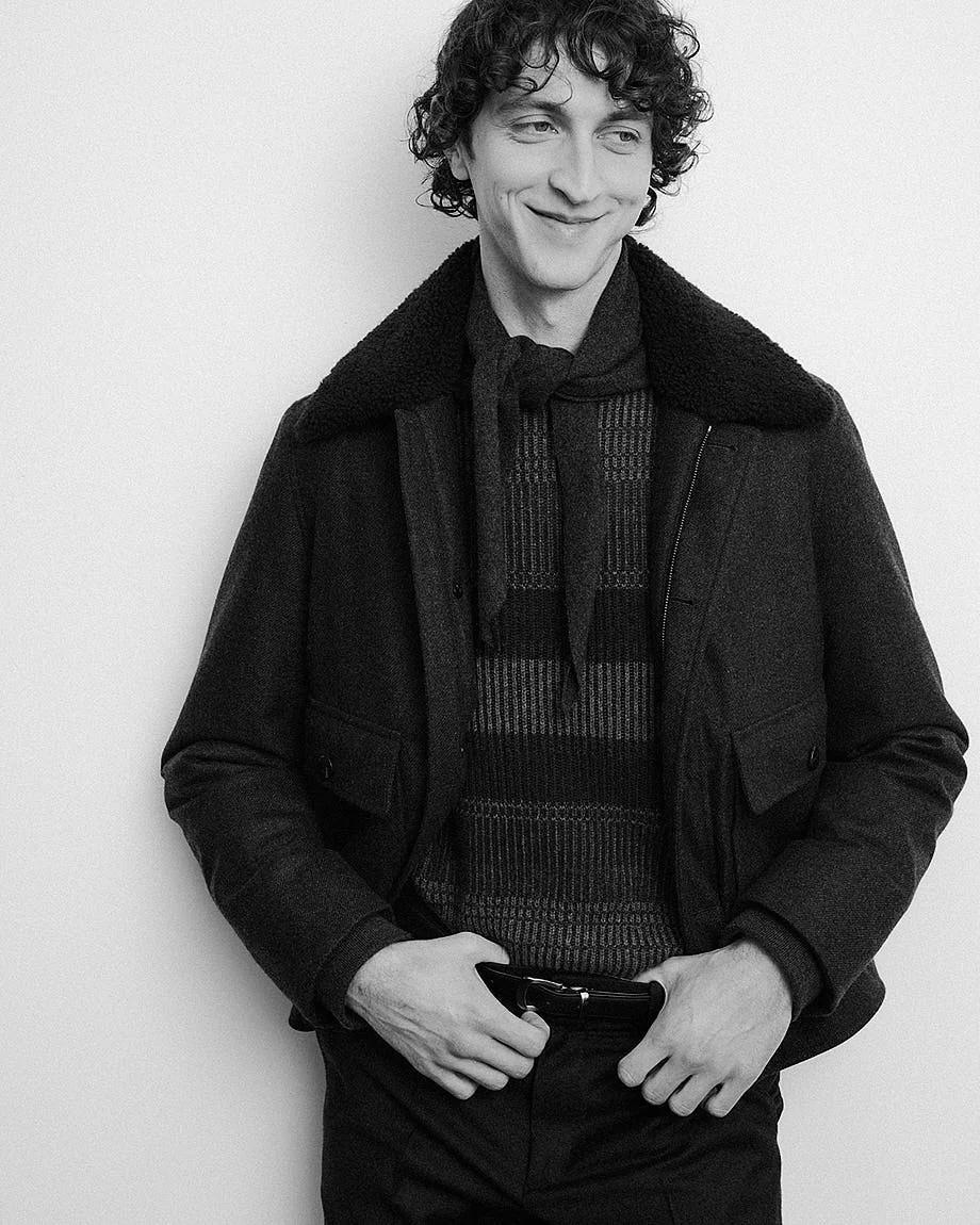 AGNONA Autumn/Winter 2026 menswear portrait with dark jacket, textured knitwear and neck scarf, LE MILE Magazine.