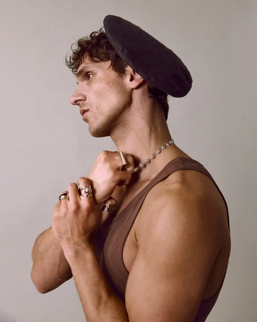 Mergim Shabani LE MILE Magazine DIGITAL COVER SS26 Mërgim wears a tank top by LOUIS VUITTON, a hat by PAUL SMITH and jewellery by LAG WORLD