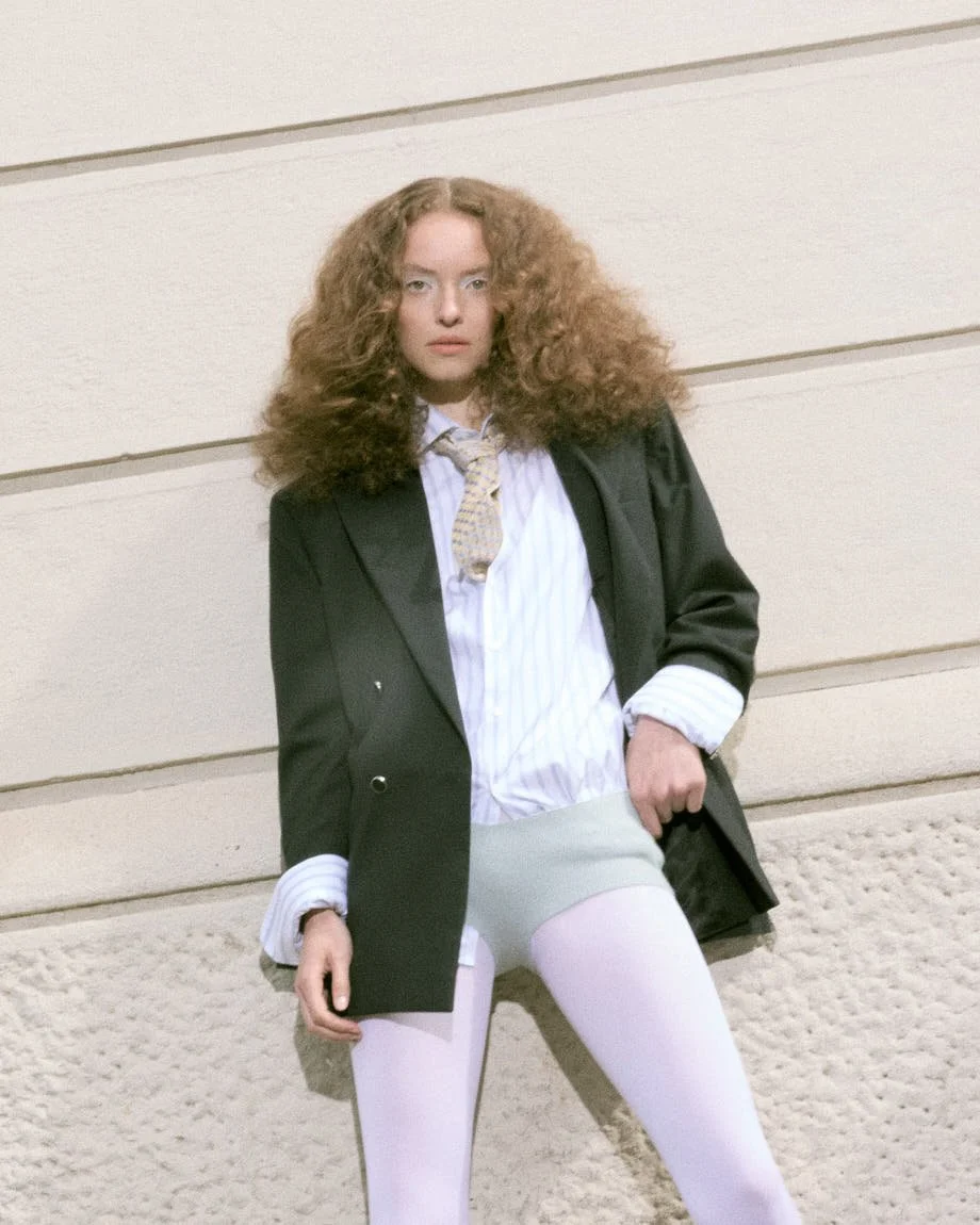 LE MILE Magazine Luisa Schumacher SS26 Editorial Luisa wears blazer by MANUEL RITZ, shirt and tie by PAL ZILERI, underwear by EXTREME CASHMERE, shoes by PAUL SMITH and tights by CALZEDONIA