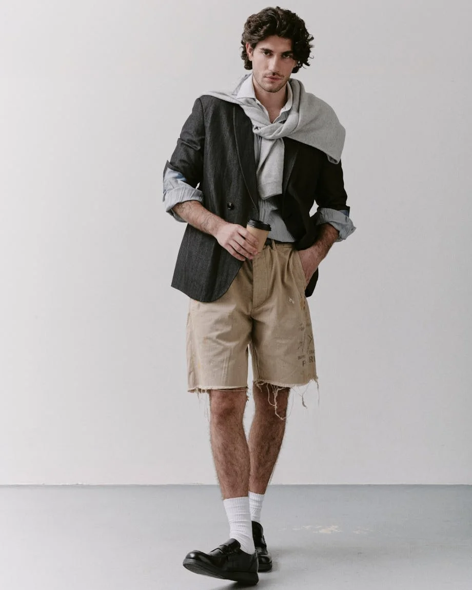 Michelangelo Vizzini photo by Andrea Cenetiempo for LE MILE Magazine CoverSS26 wearing a blazer by GIORGIO ARMANI, a sweater by SON OF A TAILOR, shirts by MOSCHINO and MICHAEL KORS, shorts by POLO RALPH LAUREN, shoes by CHURCH’S, and a belt by CELINE