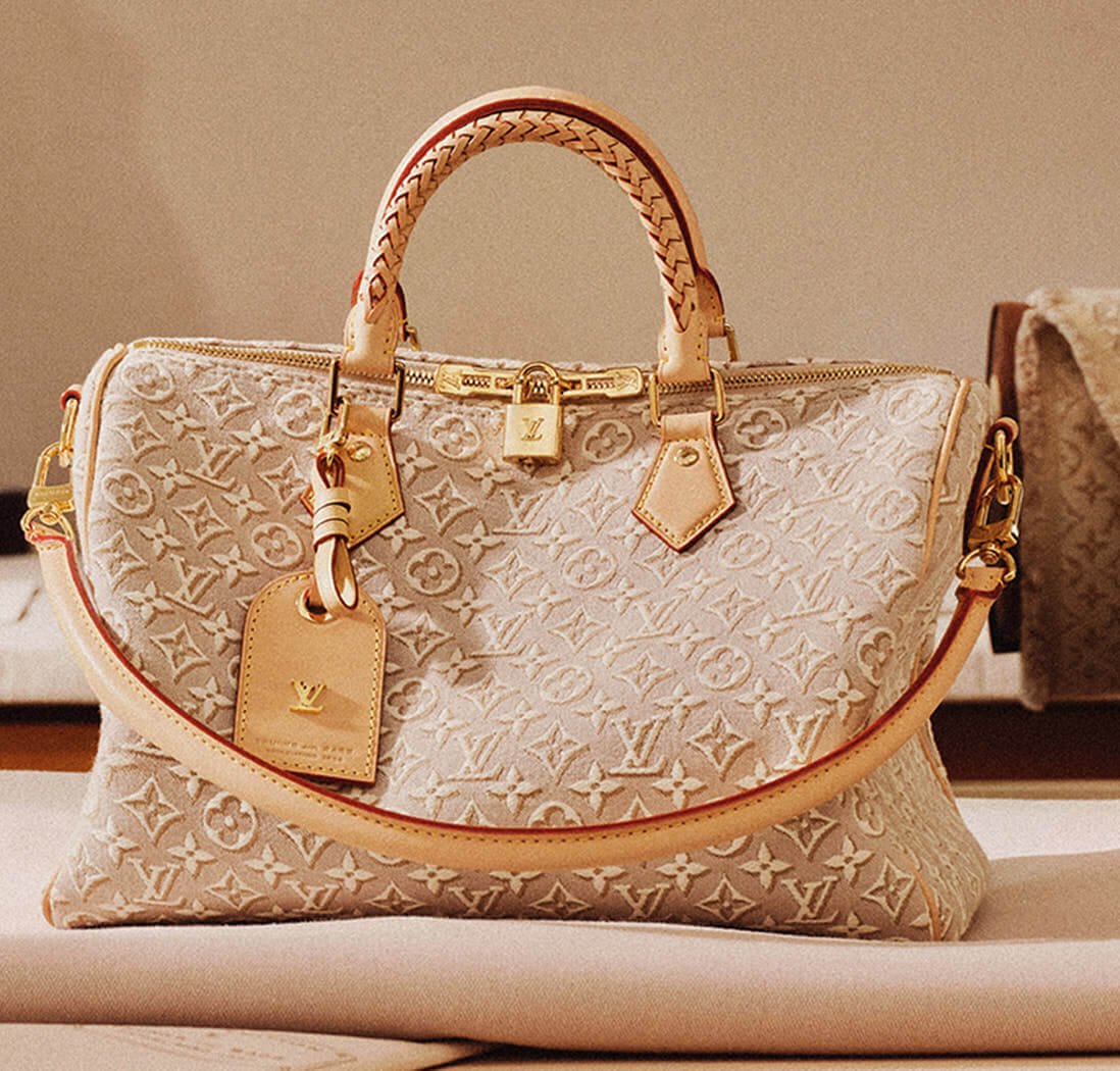 Louis Vuitton Speedy 30 Soft bag in Monogram Emblème Peuplier jacquard, shown with braided top handles, natural leather trims, gold-tone hardware, luggage tag and shoulder strap
