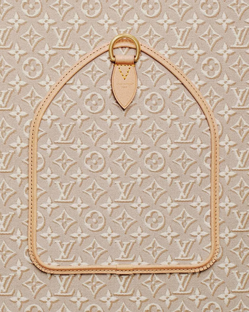 Close-up of a Louis Vuitton Speedy 30 Soft bag panel in Monogram Emblème Peuplier jacquard, showing the leather gousset, enchape detail, stitching and brass ring hardware