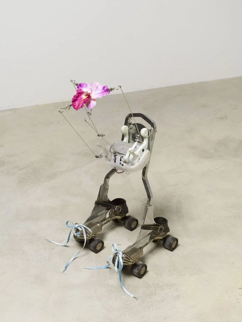 Rachel Youn, Rend, 2024, sissybar, roller skates, shoulder massager, hardware, fake flower, shoelaces, 75 × 35 × 30 cm. Image via Soy Captain LE MILE Magazine reviewed by editor Tagen Donovan