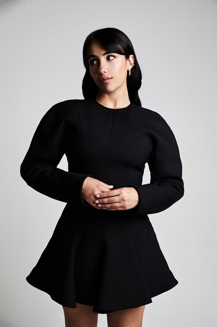 Leila wears a dress by STELLA MCCARTNEY and earrings by ALEXIS BITTAR