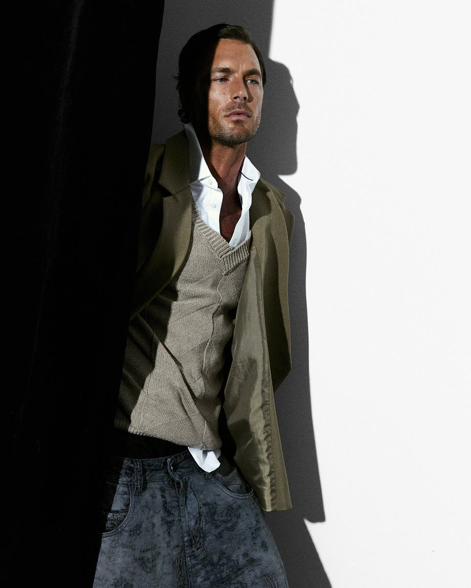LE MILE Magazine Digital Cover CHRISTIAN HOGUE SS26 Christian wears blazer by THE FRANKIE SHOP, sweater vest by CANALI, shirt by MICHAEL KORS, jeans by DIESEL and shorts by FENDI