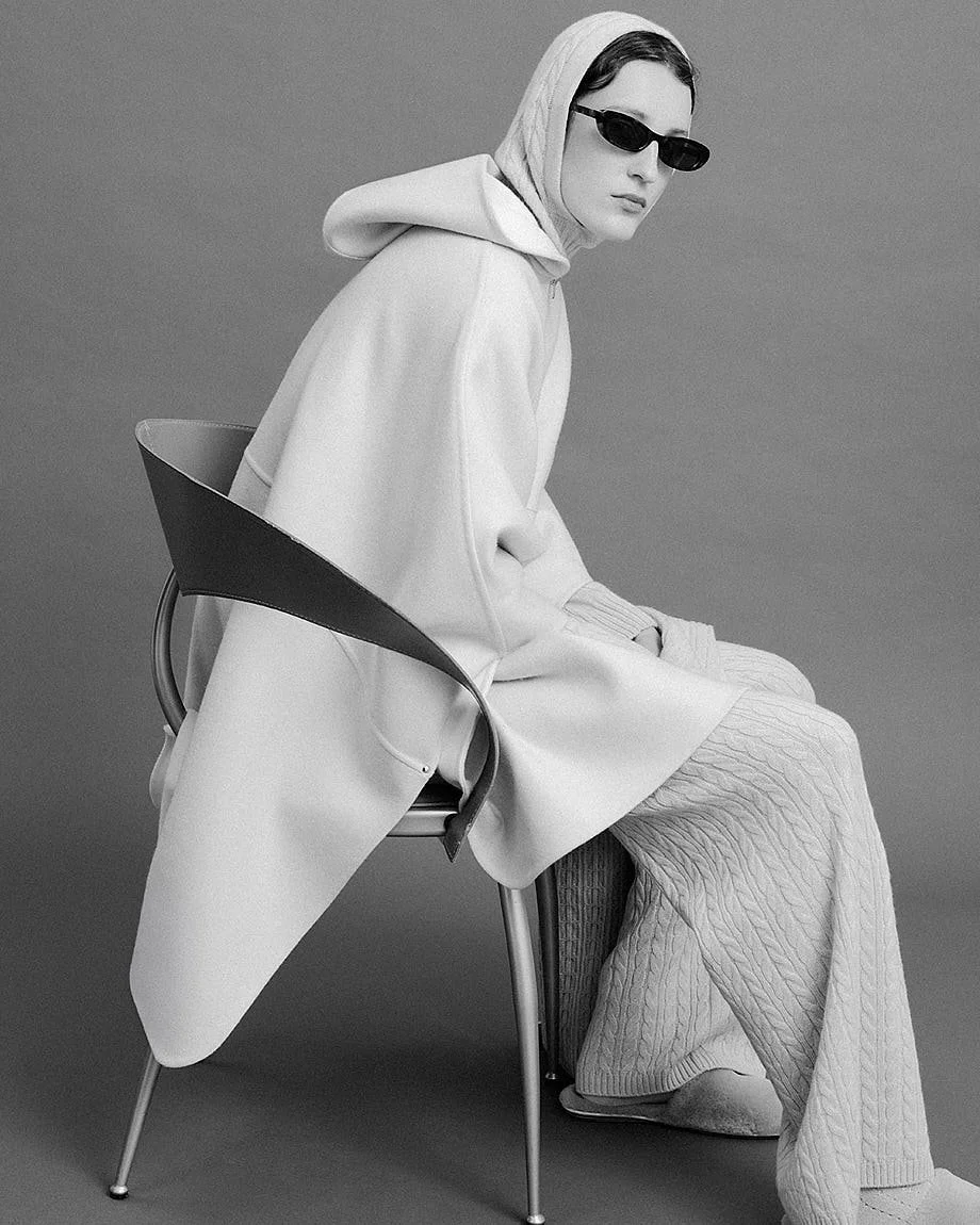 AGNONA Autumn/Winter 2026 womenswear in black and white with a light hooded cape and textured knit trousers, LE MILE Magazine.
