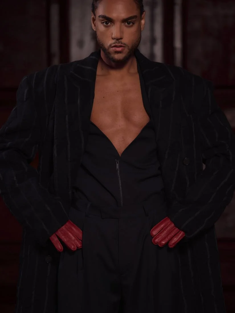 Lamin Leroy Gibba stylist Klass Hammer photo Leon Nevill Gallagher LE MILE Magazine Lamin wears a coat by Juun.J, a blazer and pants by Karl Lagerfeld, and gloves by H&M Studio