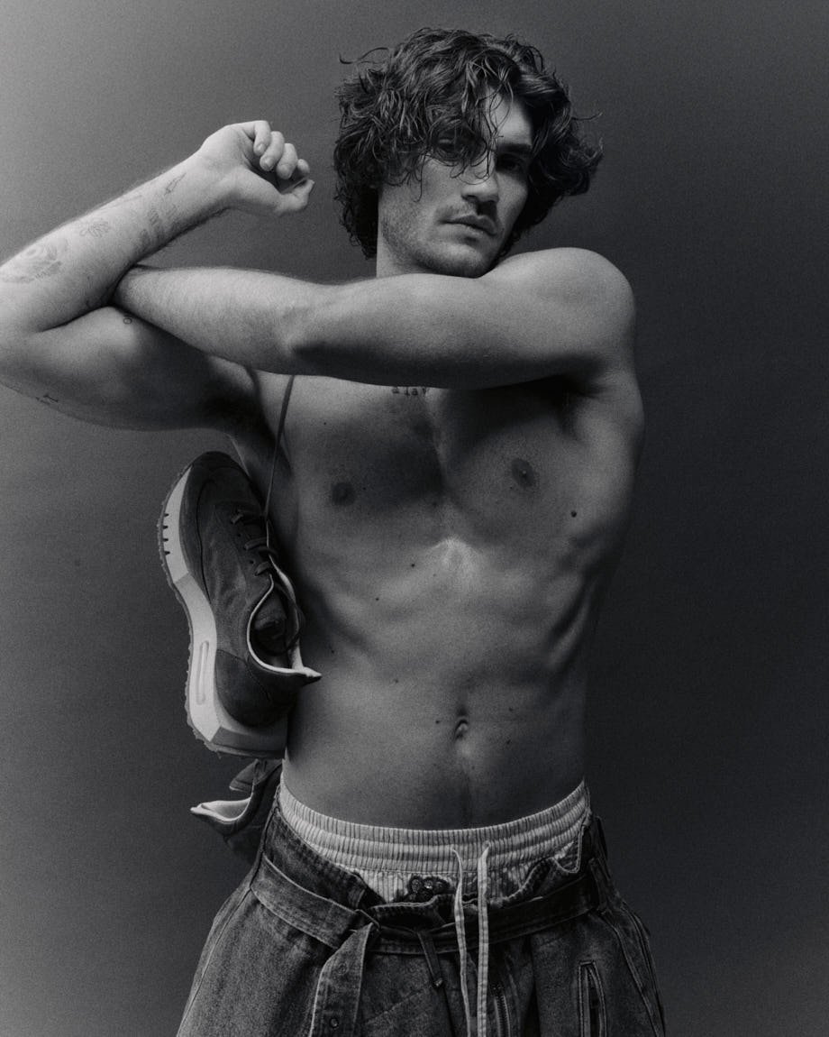 Michelangelo Vizzini photo by Andrea Cenetiempo for LE MILE Magazine CoverSS26 wearing jeans by HED MAYNER, shorts by ESSENTIEL ANTWERP, and shoes by BEPOSITIVE