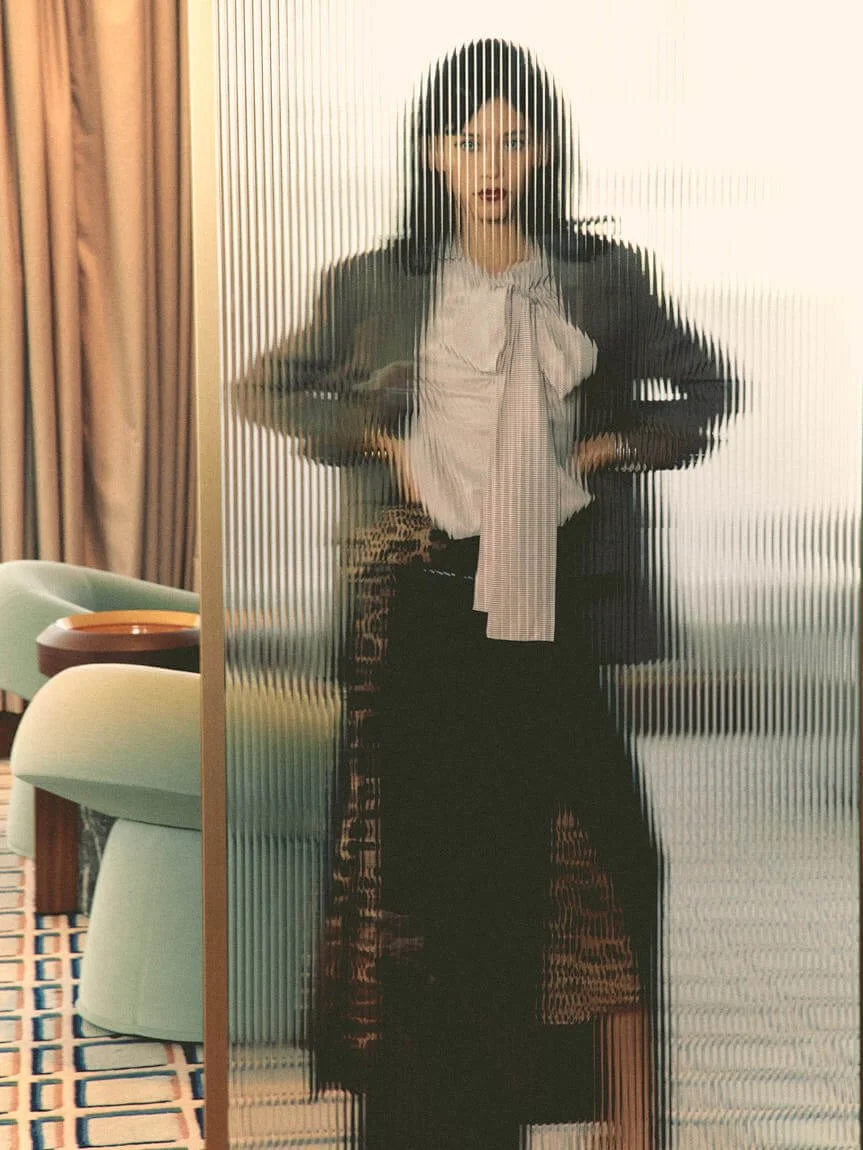 MARIA MAVAREZ LE MILE Magazine photo Cosimo Buccolieri SS26 Fashion Editorial Maria wears blazer by MOSCHINO, shirt by QL2, printed skirt, shoes and scarf by DOLCE&GABBANA, and black skirt by DSQUARED2
