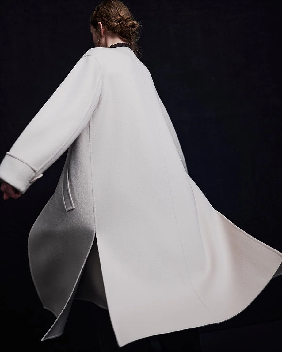 AGNONA Autumn/Winter 2026 white coat photographed in movement, showing fluid construction and volume, LE MILE Magazine.