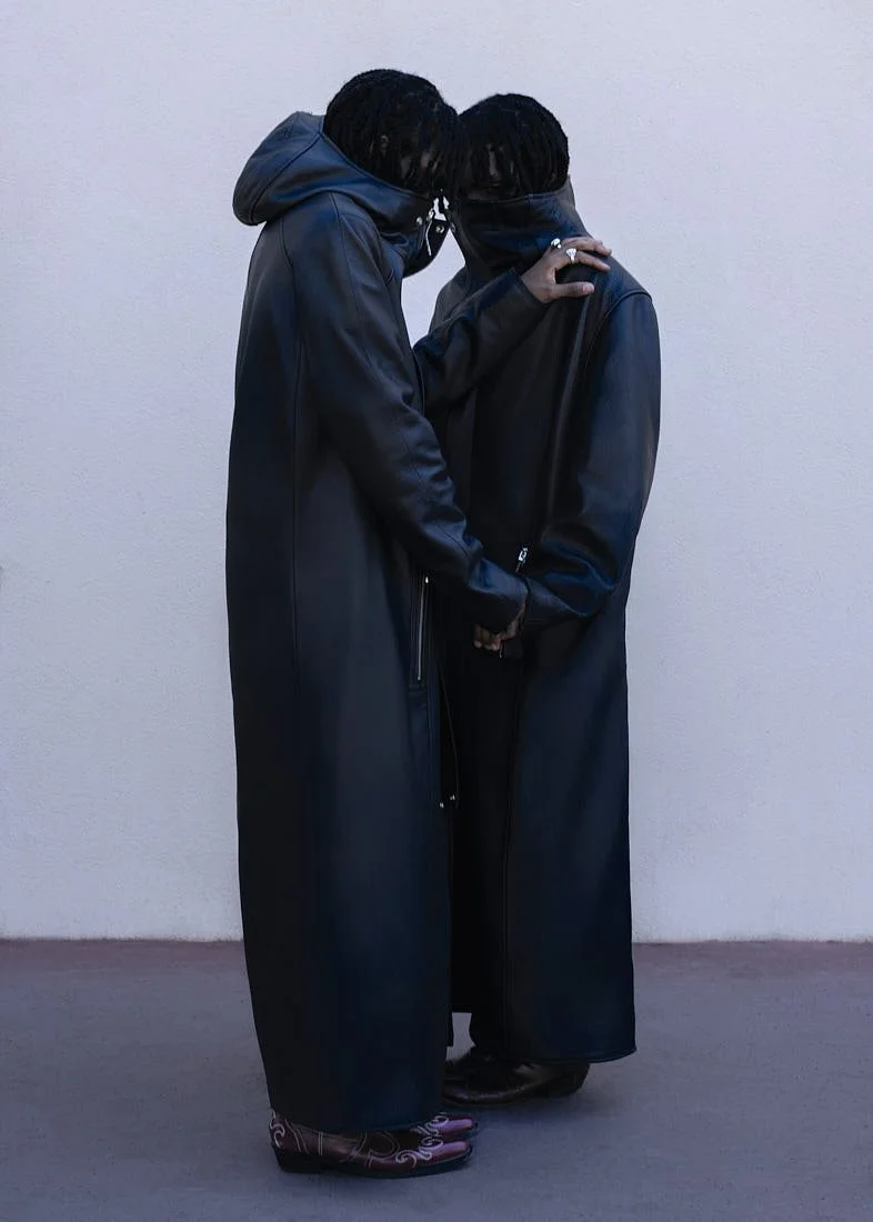 The Atanga Twins for LE MILE Magazine photo by-Olesya Parfenyuk Carlsen and Curtis Atanga wear coats by TAREET and boots by DSQUARED2