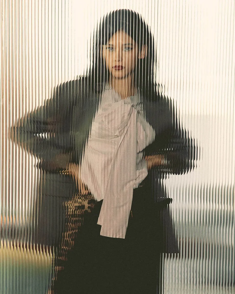 MARIA MAVAREZ LE MILE Magazine photo Cosimo Buccolieri SS26 Fashion Editorial Maria wears blazer by MOSCHINO, shirt by QL2, printed skirt, shoes and scarf by DOLCE&GABBANA, and black skirt by DSQUARED2