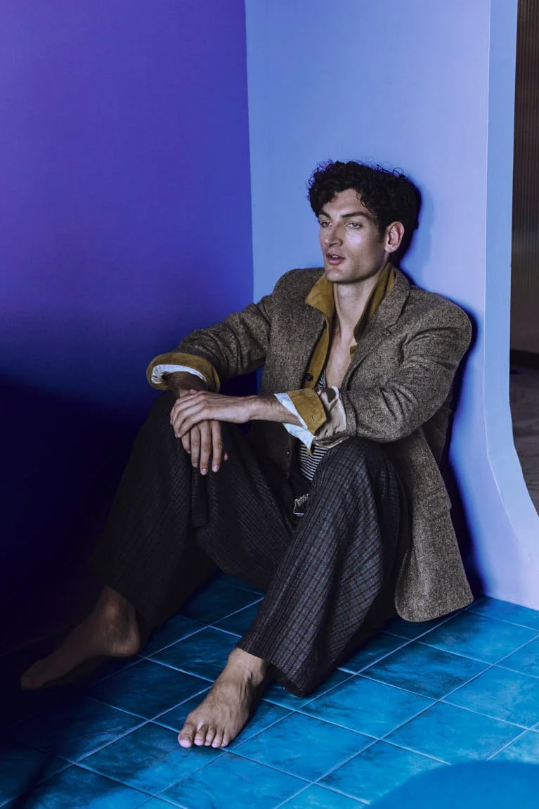 Aaron Shandel for LE MILE Magazine photographer Cosimo Buccolieri Issue 41 FW26 Deja Vu Cover Aaron wears a blazer by CELINE, a jacket by TOD’S, a tank top by ISABEL MARANT, pants by EMPORIO ARMANI and shorts by VLISCO