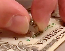 Lens machined on Pocket NC V2-10 machine magnifying letters on a US dollar.