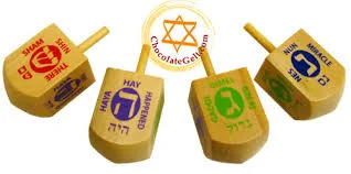 dreidels showing Hebrew letters Shin, Heh, Gimel, and Nun respectively