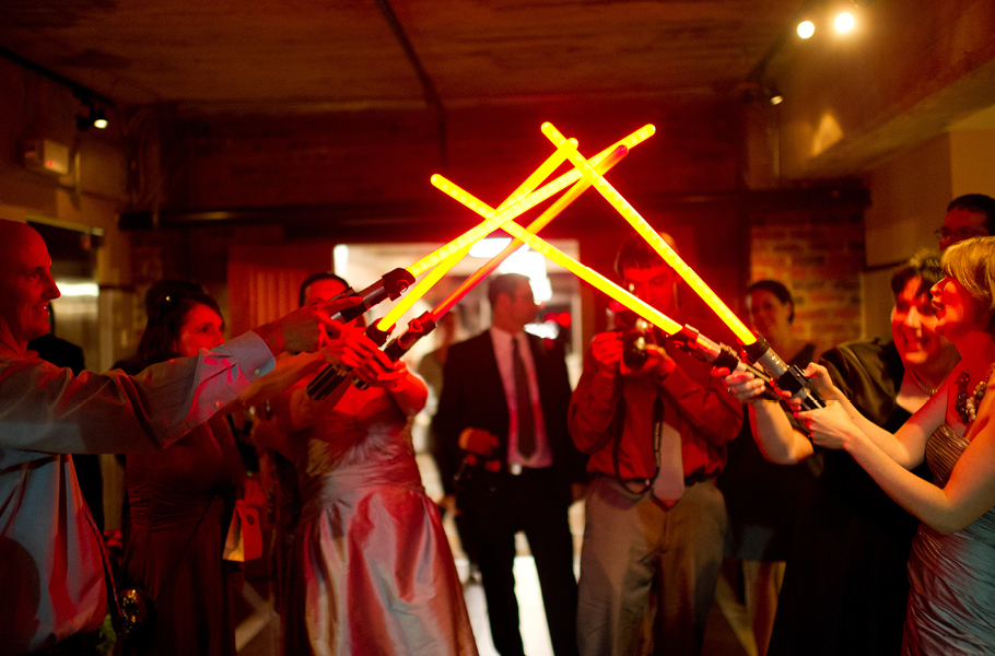  People always warn you about how fast your wedding day will go, and they aren't kidding.  Here's our exit through the light sabers. (You have to let the geeks make decisions too.) 