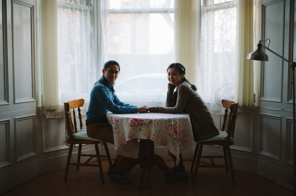 019-Couple-Wedding-Portrait-Boy-Girl-Sitting-at-table-holding-hands.jpg