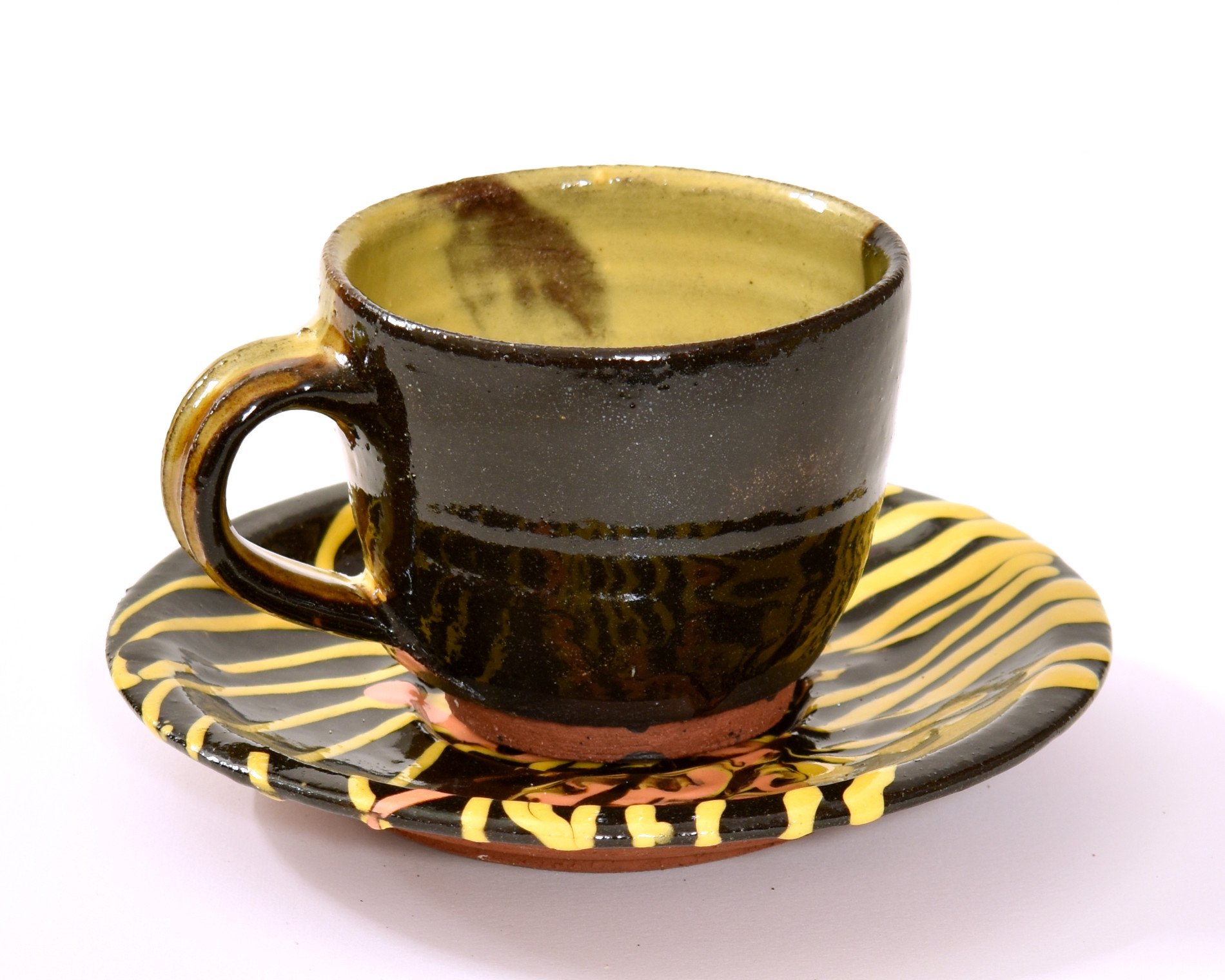   Cup &amp; saucer , 2023, single-fired terracotta, slips, clear &amp; honey glaze, cup height: 7.5cm, saucer diameter: 16.5cm 