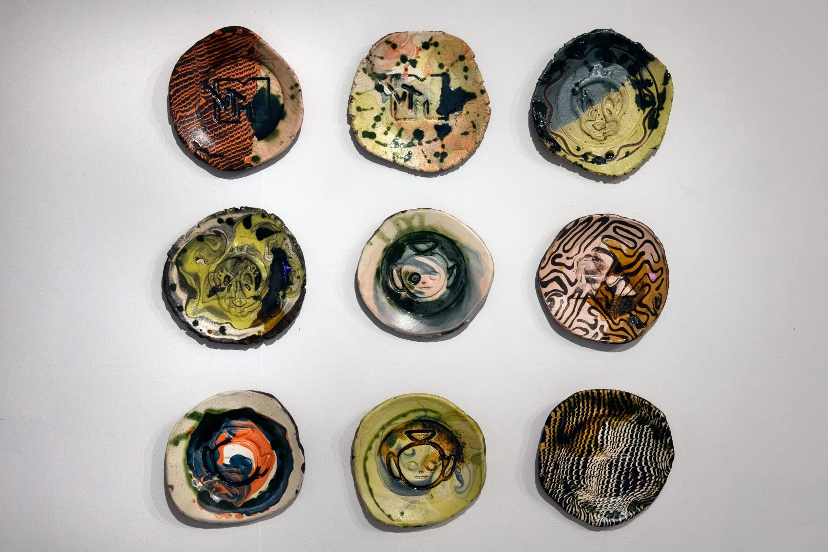   Pill press plates (Mitsubishi / MTV / Tweety Pie / Teletubby) , single-fired terracotta, slips, matt glaze, copper glaze, honey glaze, spangles 