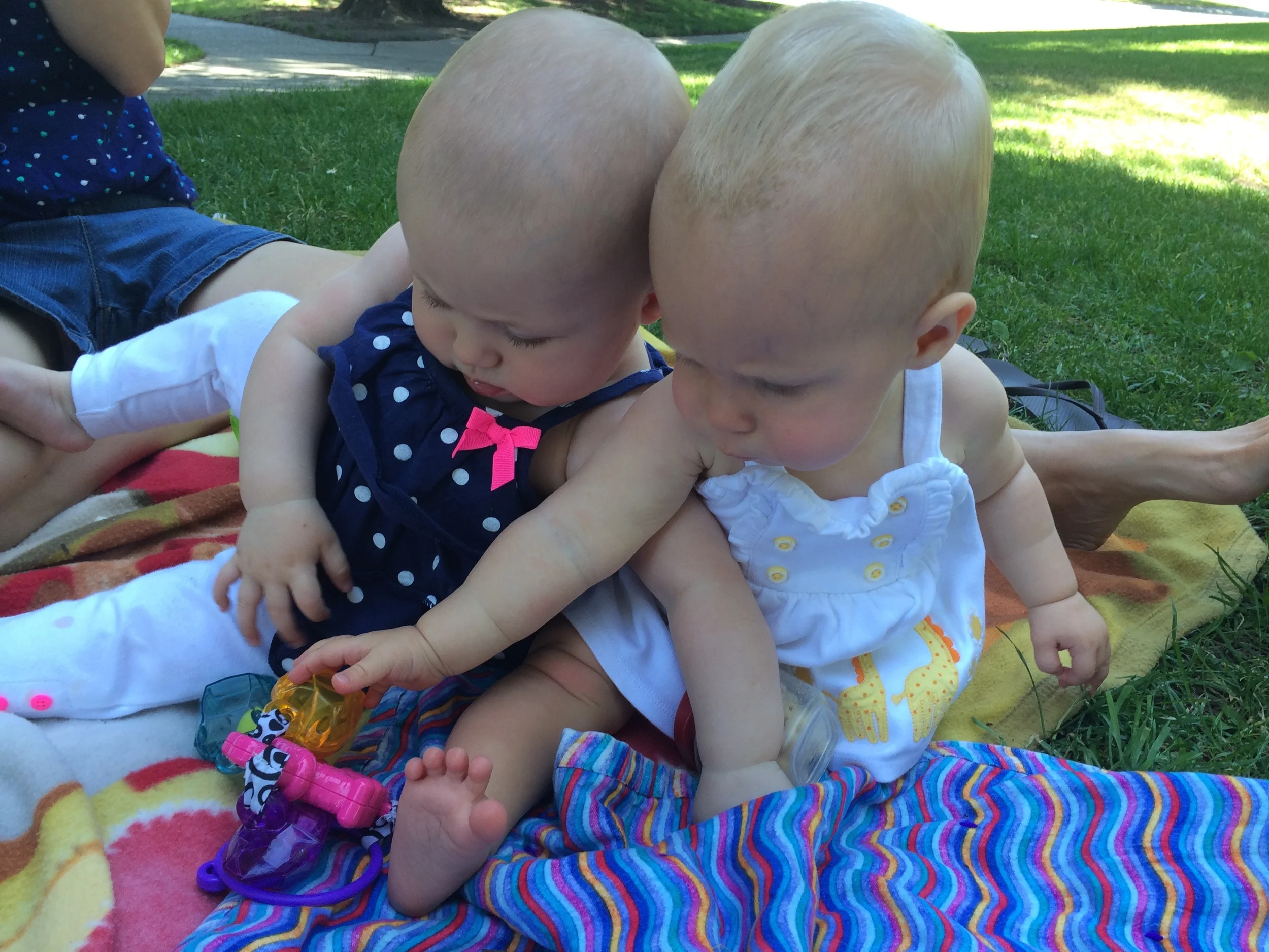 Laken throwing in her shoulder to fend off Taylor who wants her toy 
