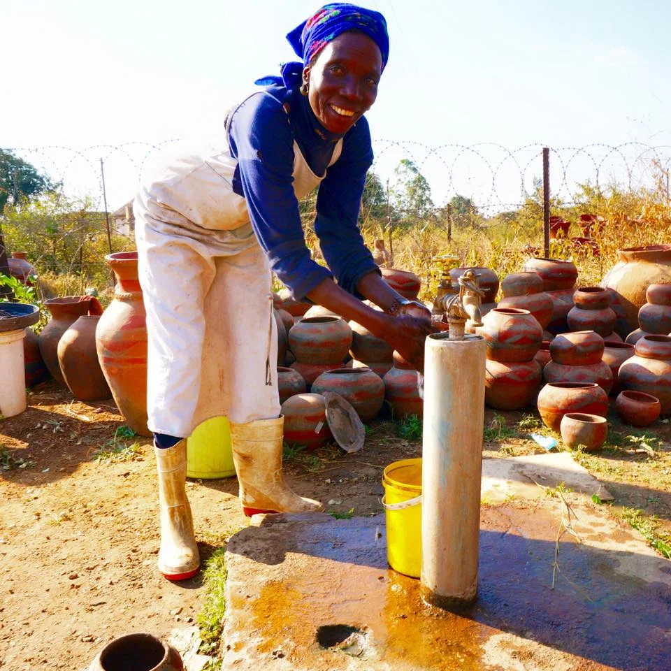 Marta collects water from the Mukondeni Factory borehole that PureMadi installed. Boreholes are the primary source of water for villagers, who often have to walk miles to collect it. Using PureMadi filters, a family is ensured safe drinking water.