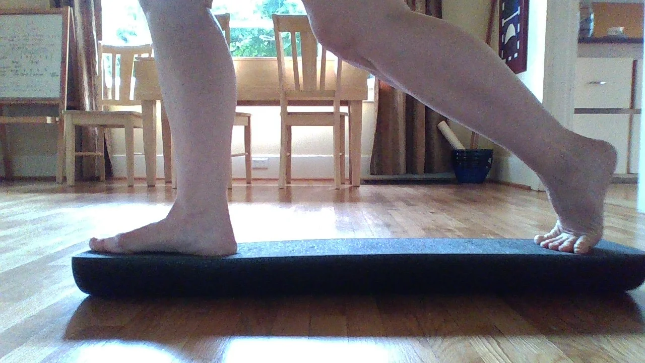 BOTH feet on the roller, hard side up.