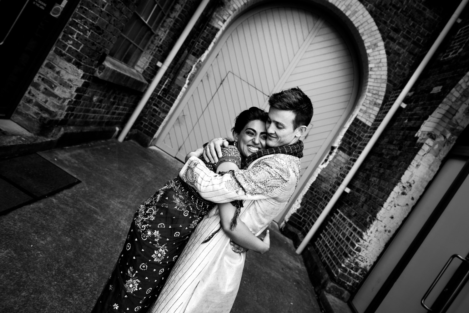 A husband and wife hug at Carriageworks
