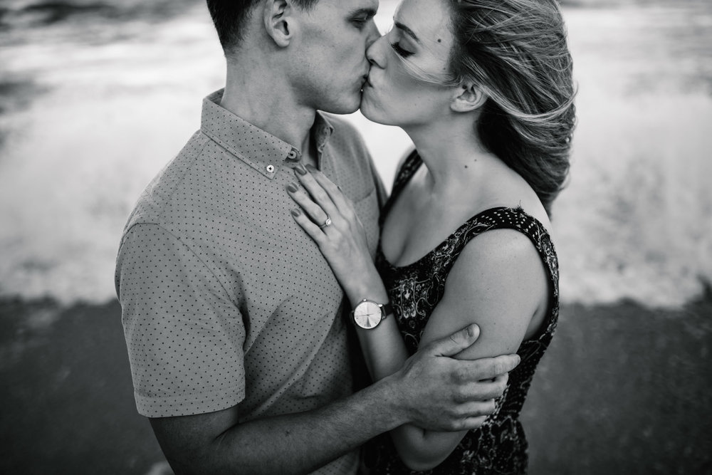 Engaged couple kissing