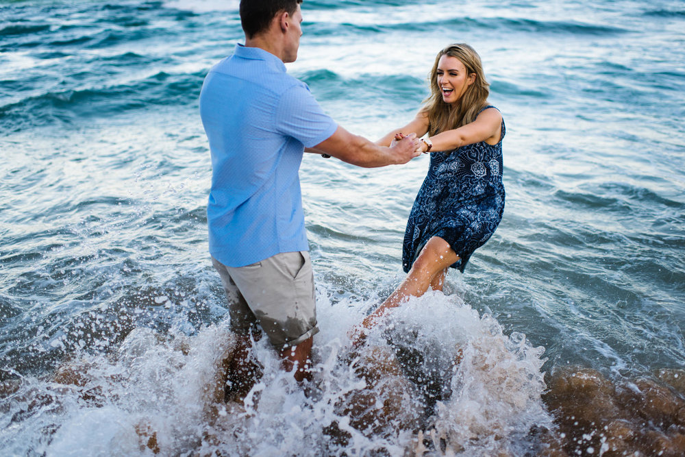 Engaged couple in the ocean