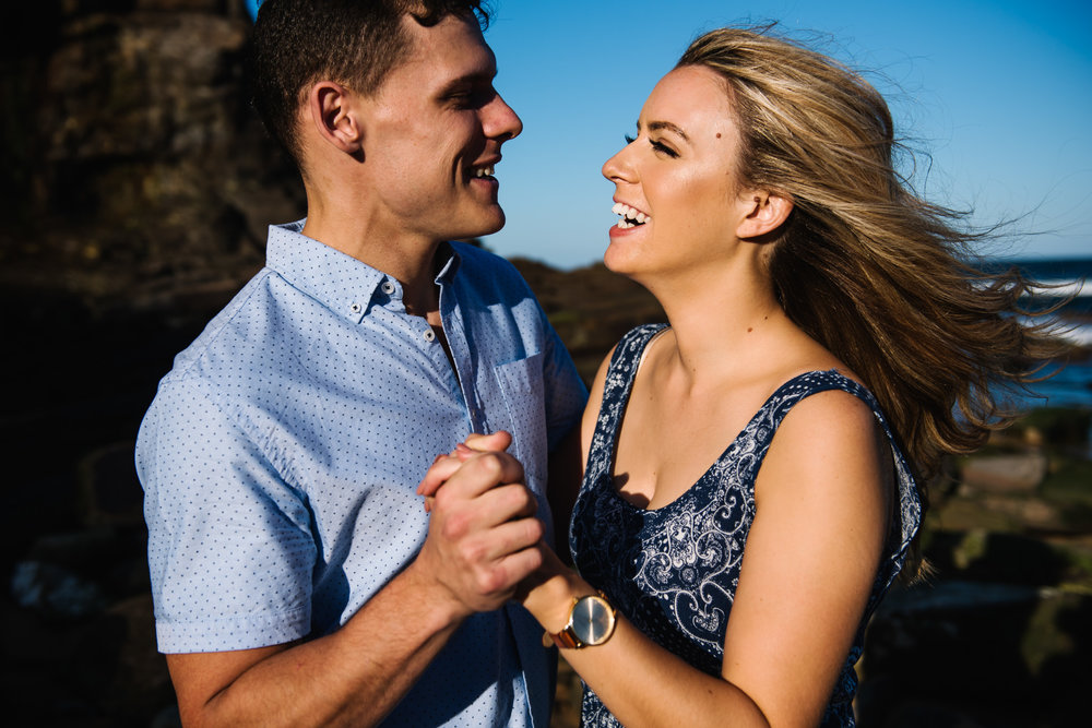 Happy engaged couple at beach