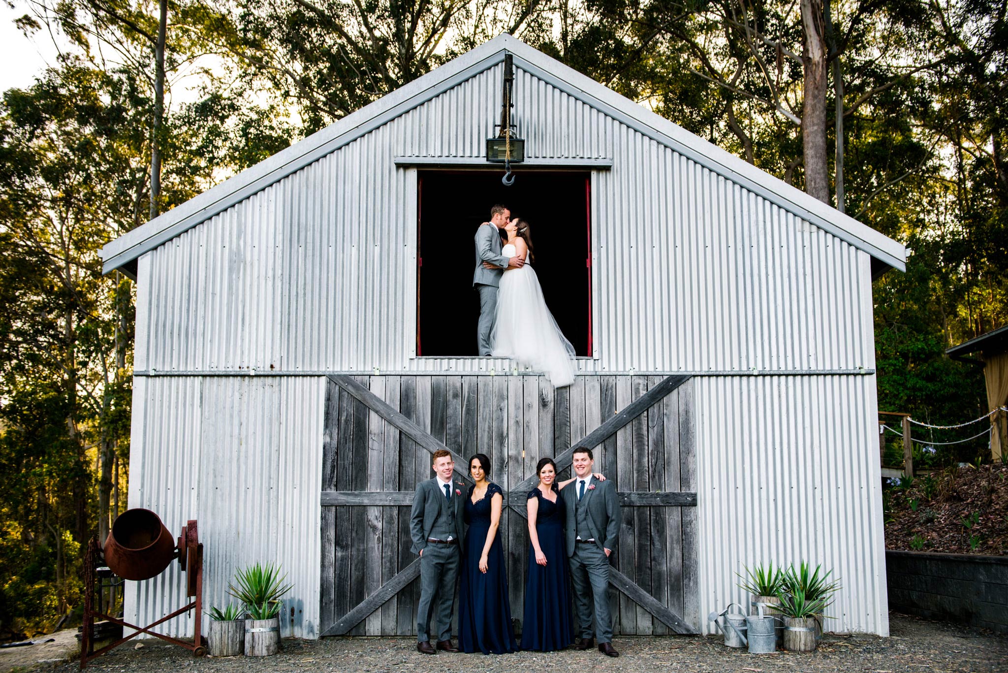 Greenfield Farm Estate bride and groom in the barn above wedding party