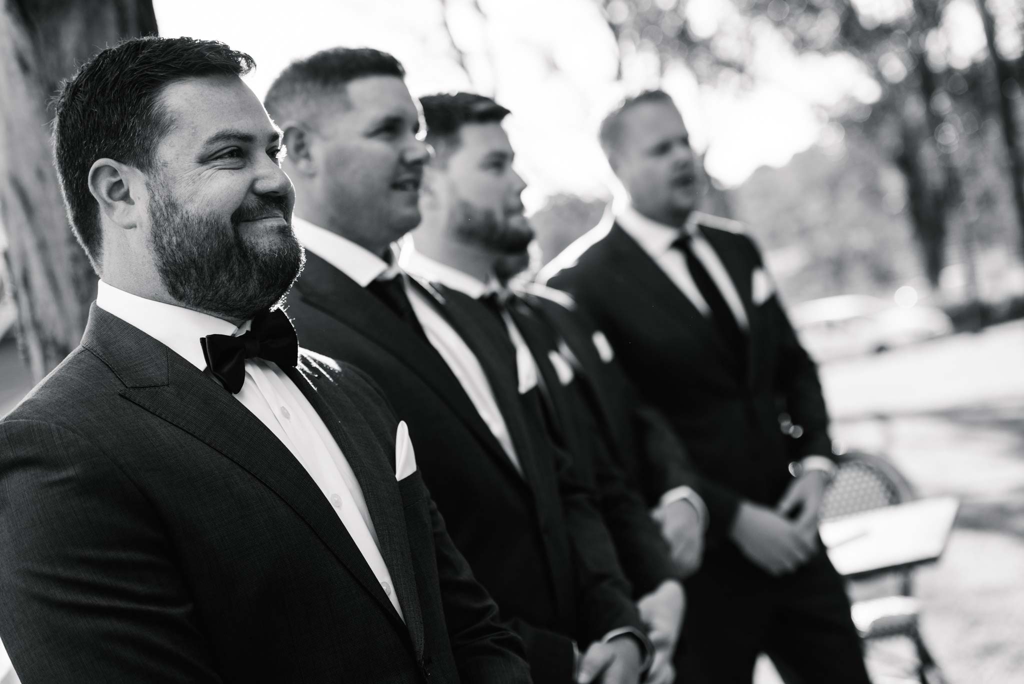 Groom watches bride walk down aisle