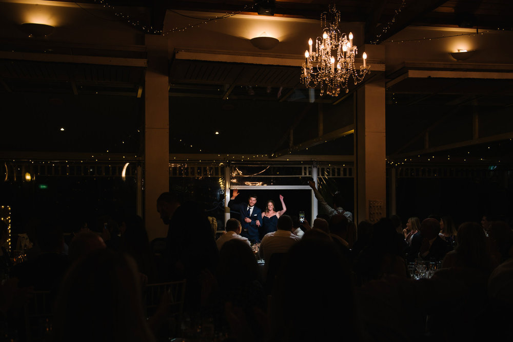 Bridesmaid and groomsman enter wedding reception at Wandin Valley Estate