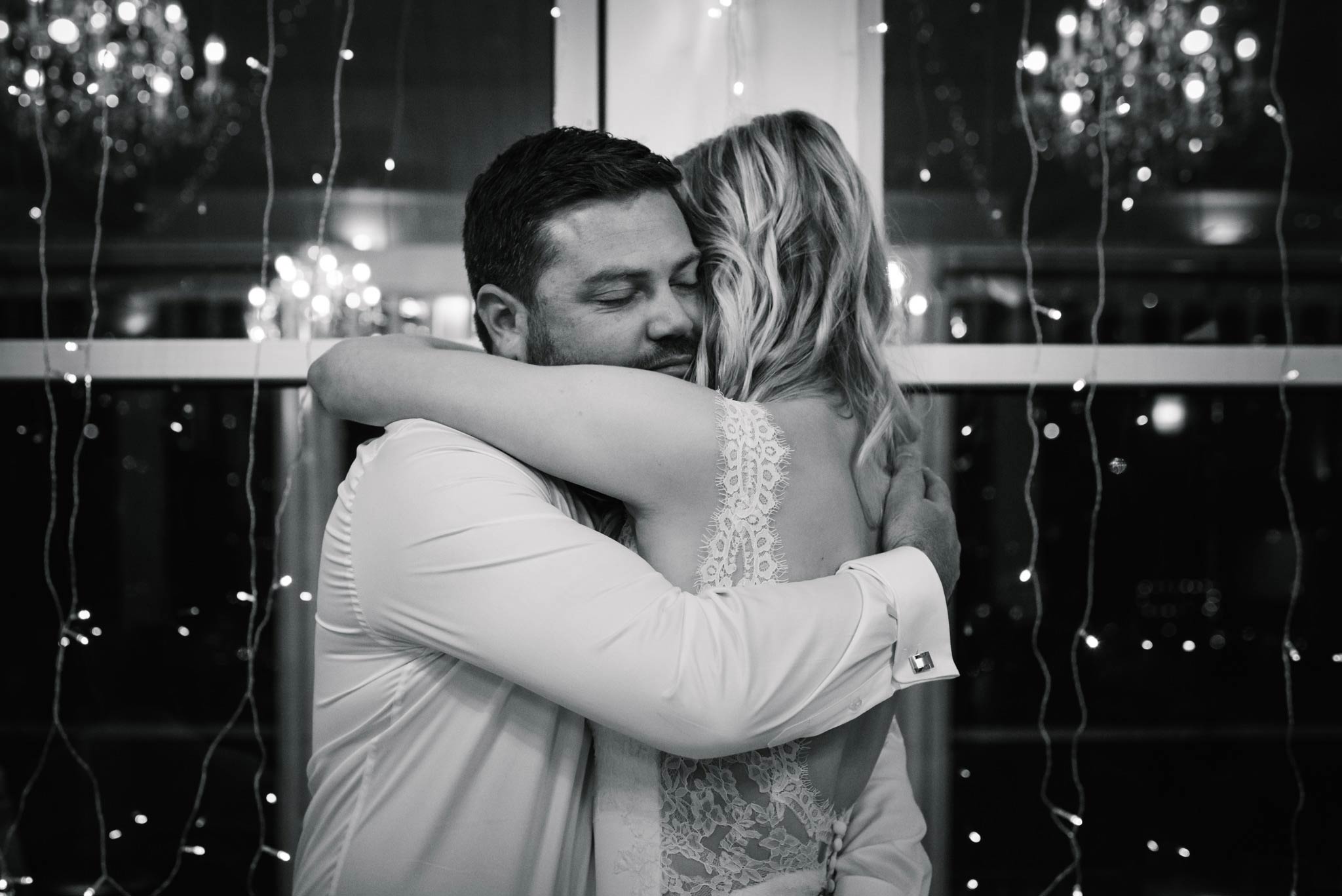 Bride and groom embrace after groom's speech