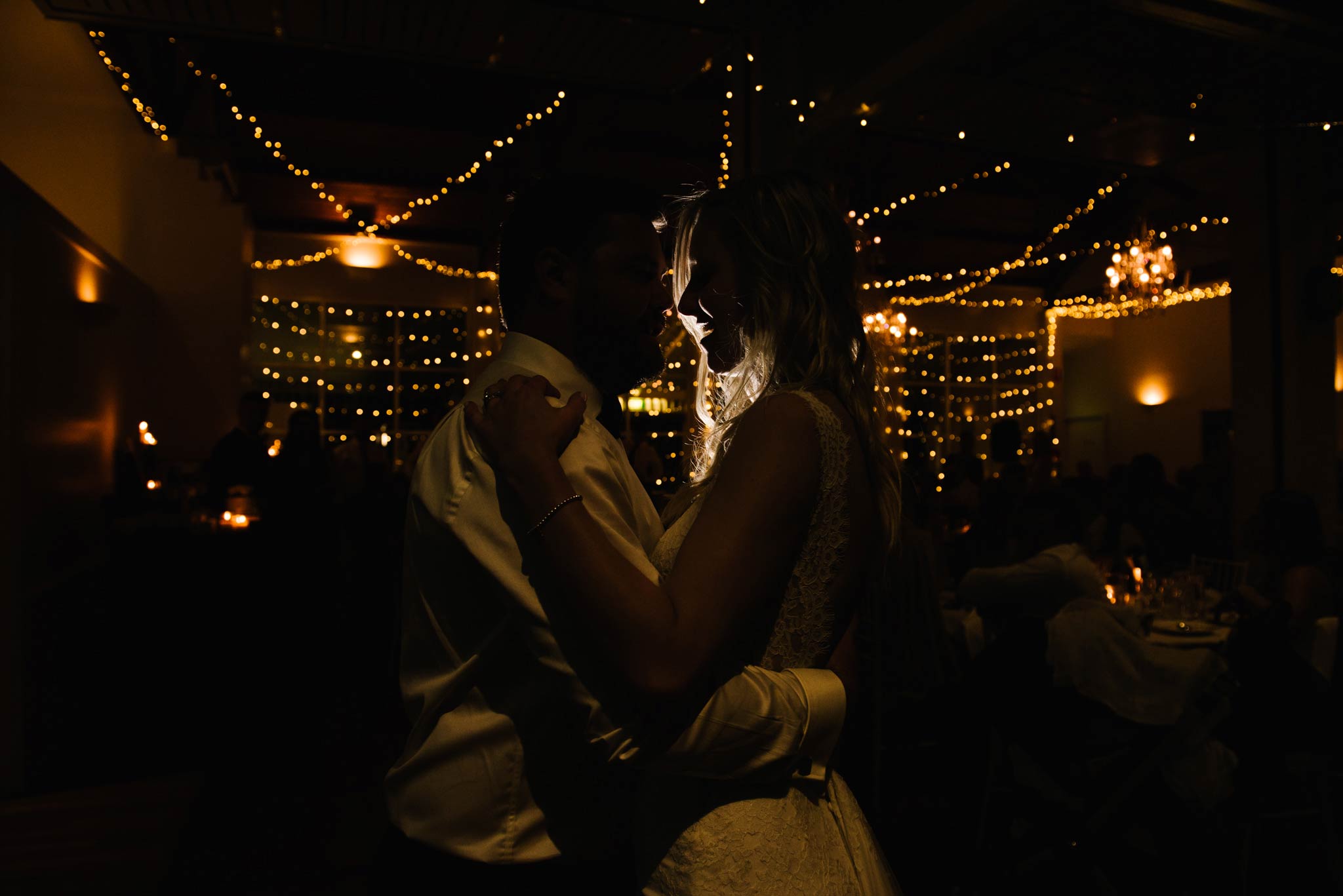 Silhouette of bride and groom during first dance