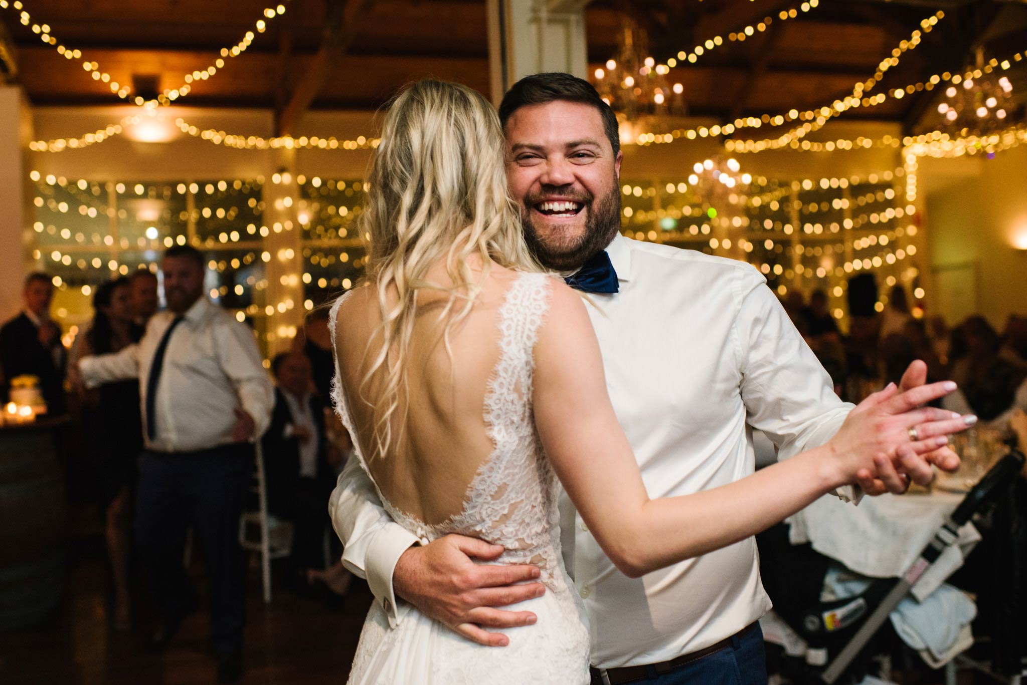 Groom smiling during first dance with bride