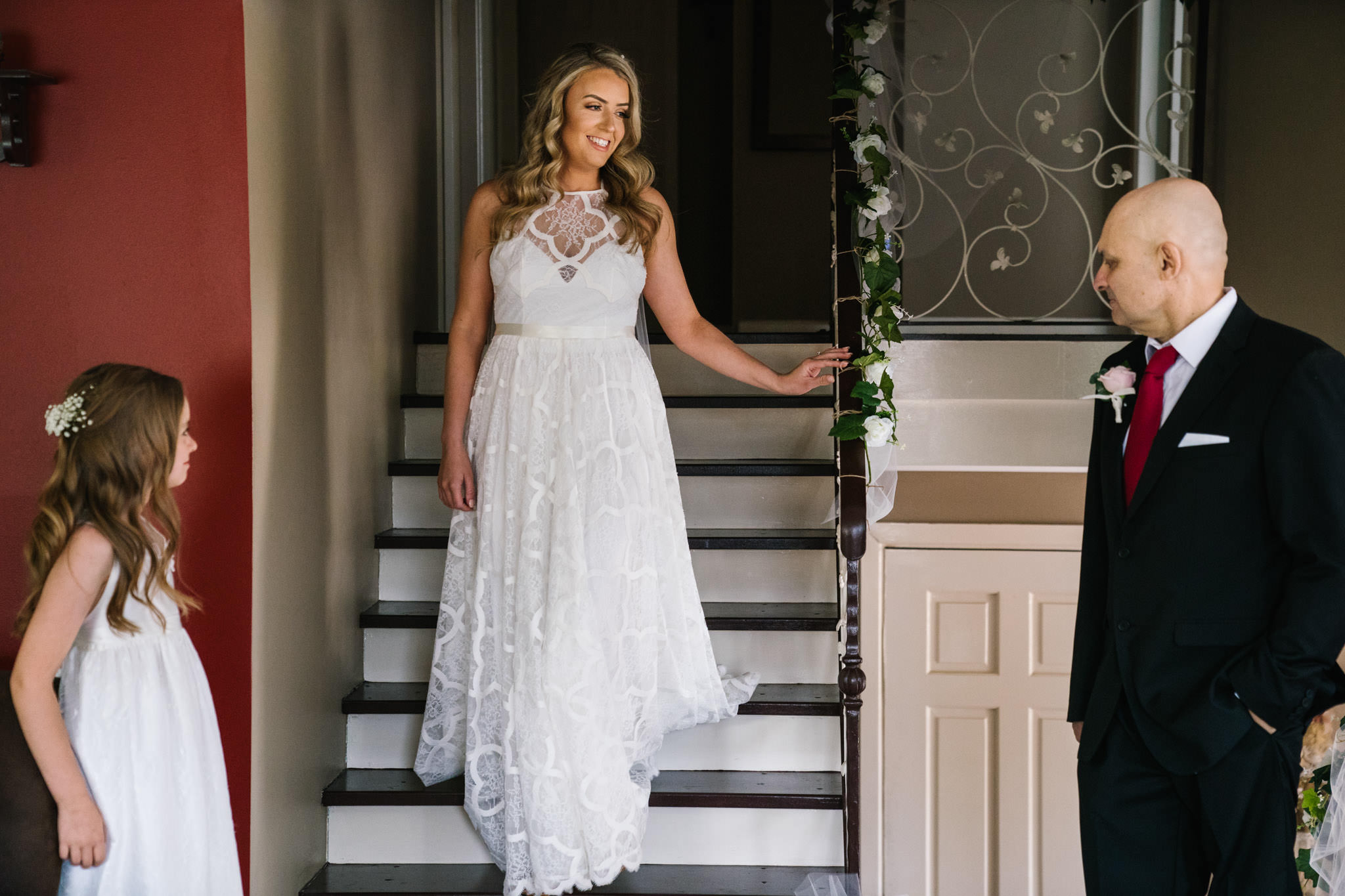 Dad and bridesmaid see bride in her gown for the first time