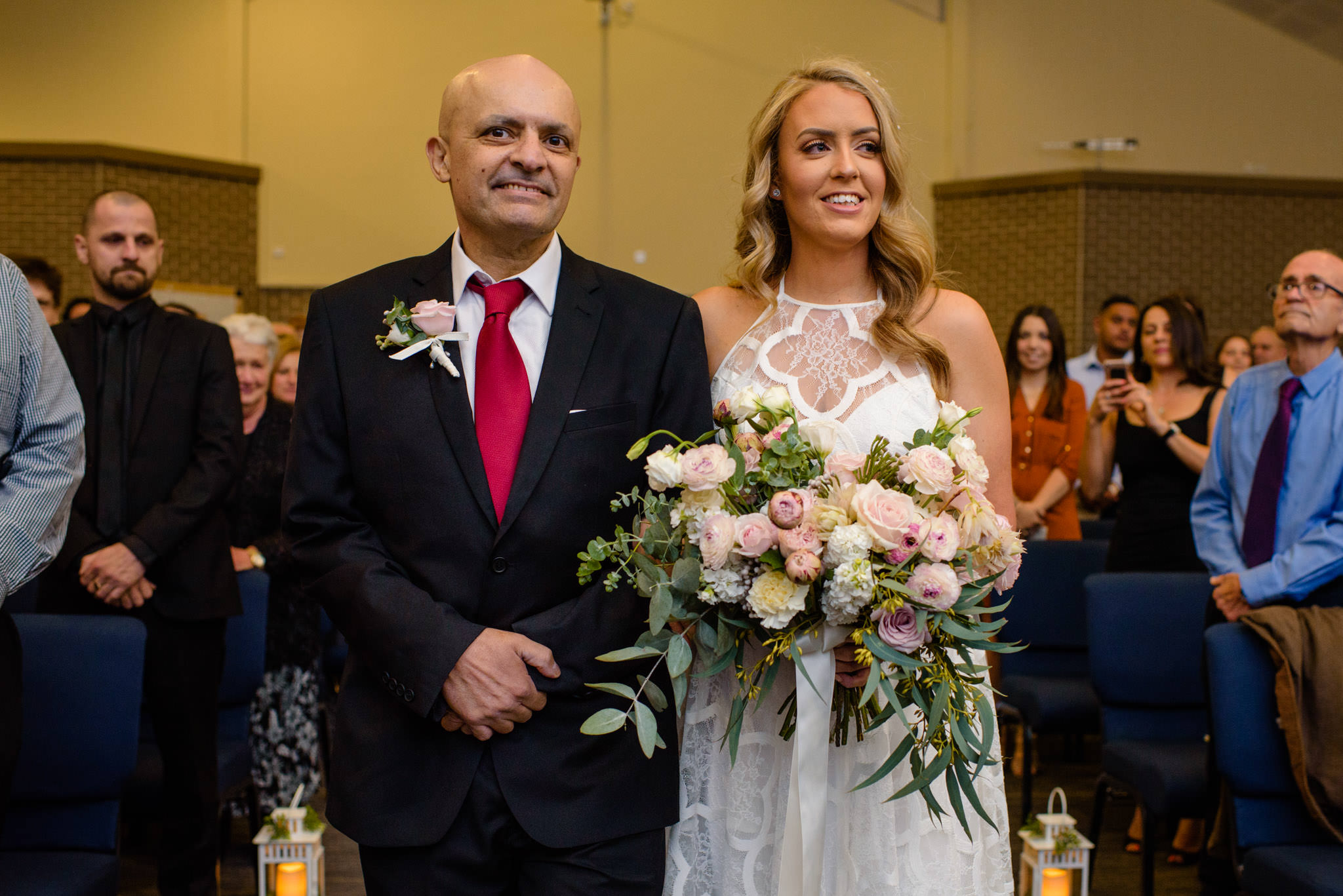 Happy father walks bride down the aisle