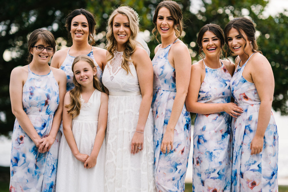 Bride and bridesmaids smiling and laughing